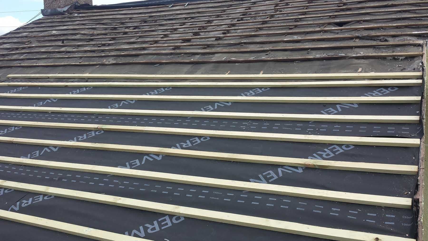 New battens fixed over membrane up the slope of a tiled roof